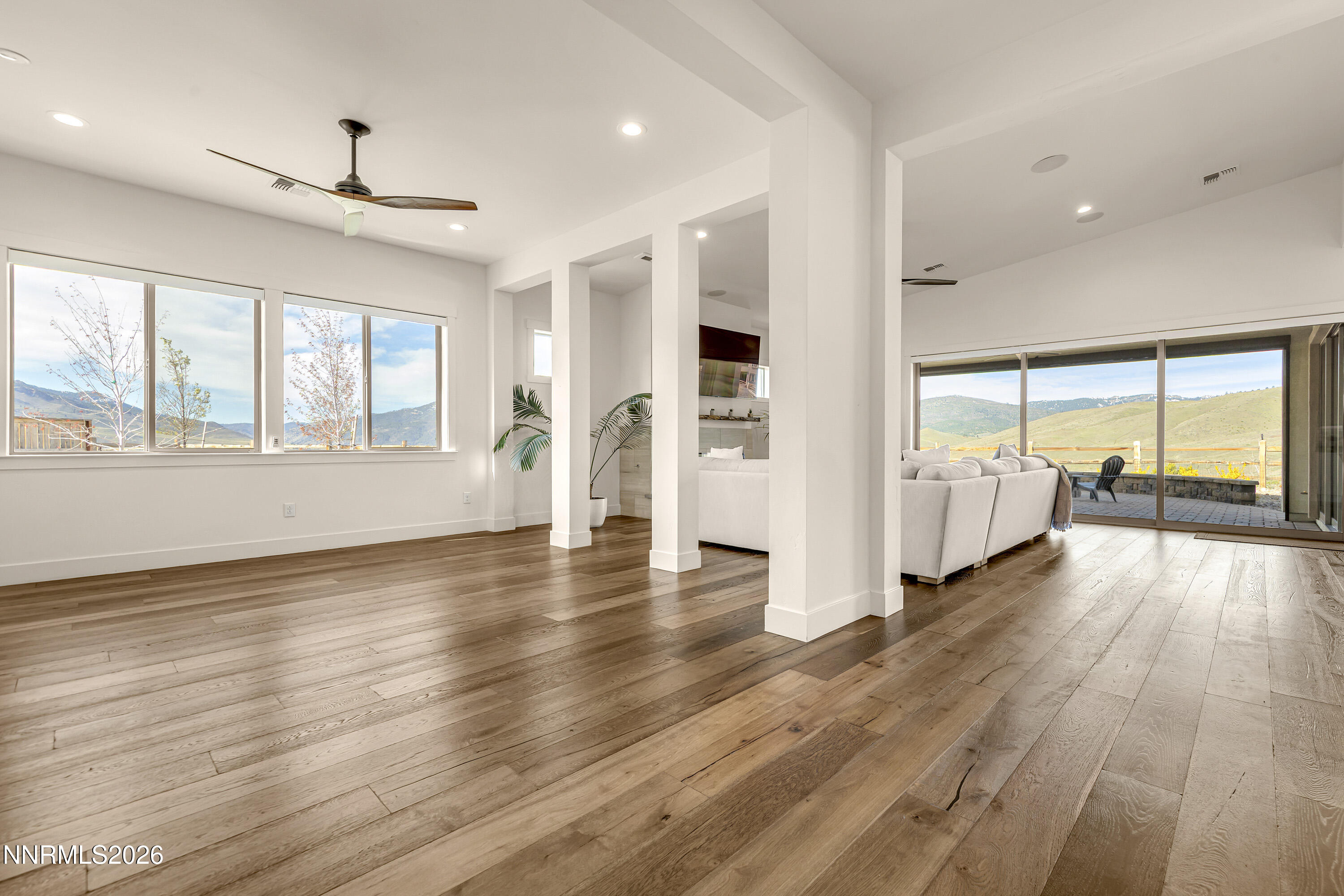 9219 Wild Skies Court Reno, NV 89523 - Photo 7 of 38 an empty room with wooden floor and windows