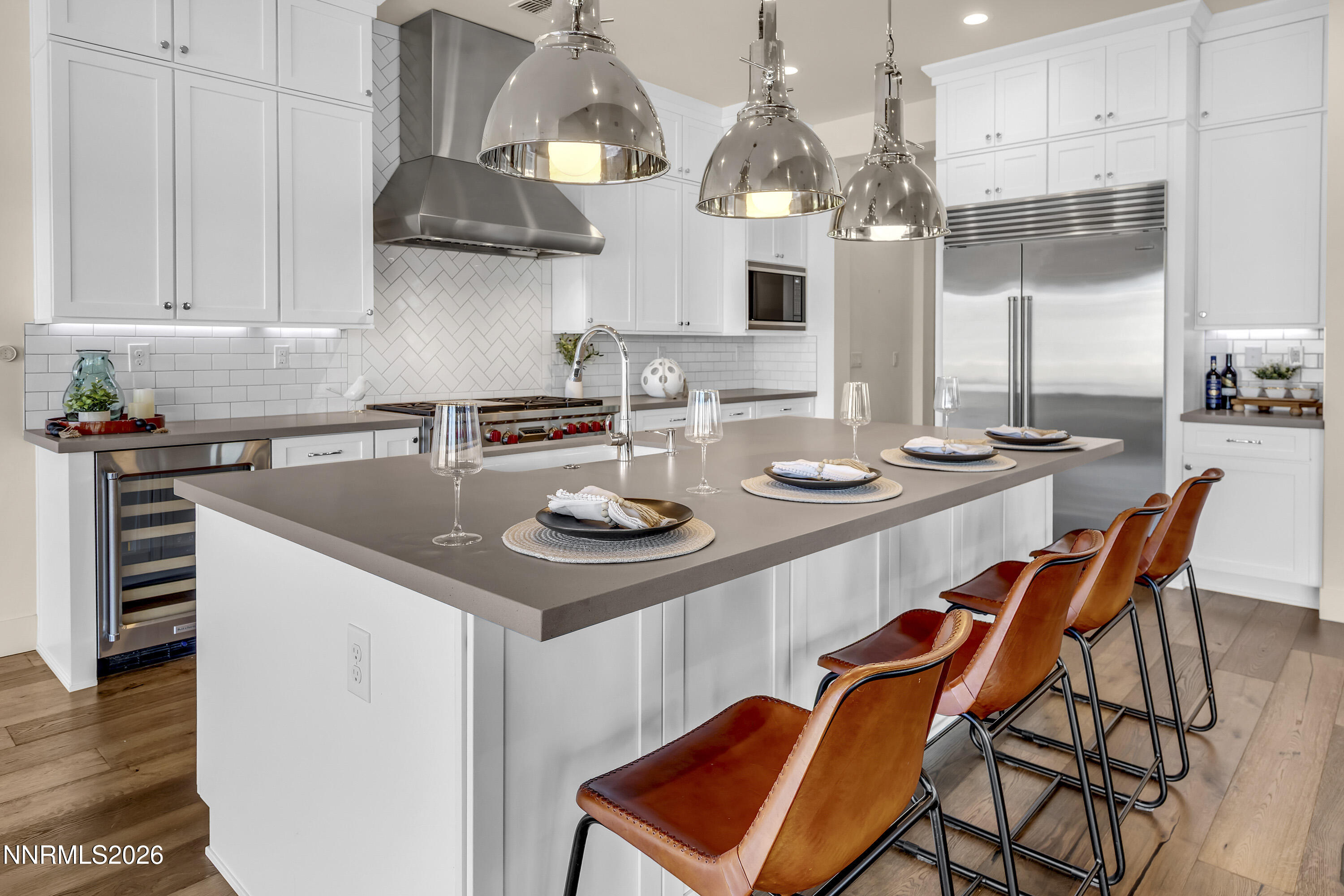 9219 Wild Skies Court Reno, NV 89523 - Photo 9 of 38 a kitchen with stainless steel appliances a sink a stove and chairs