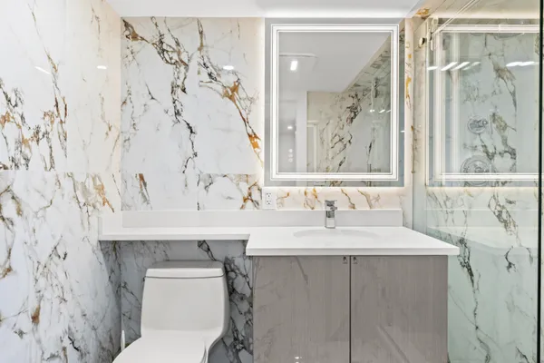 a bathroom with a sink toilet and shower