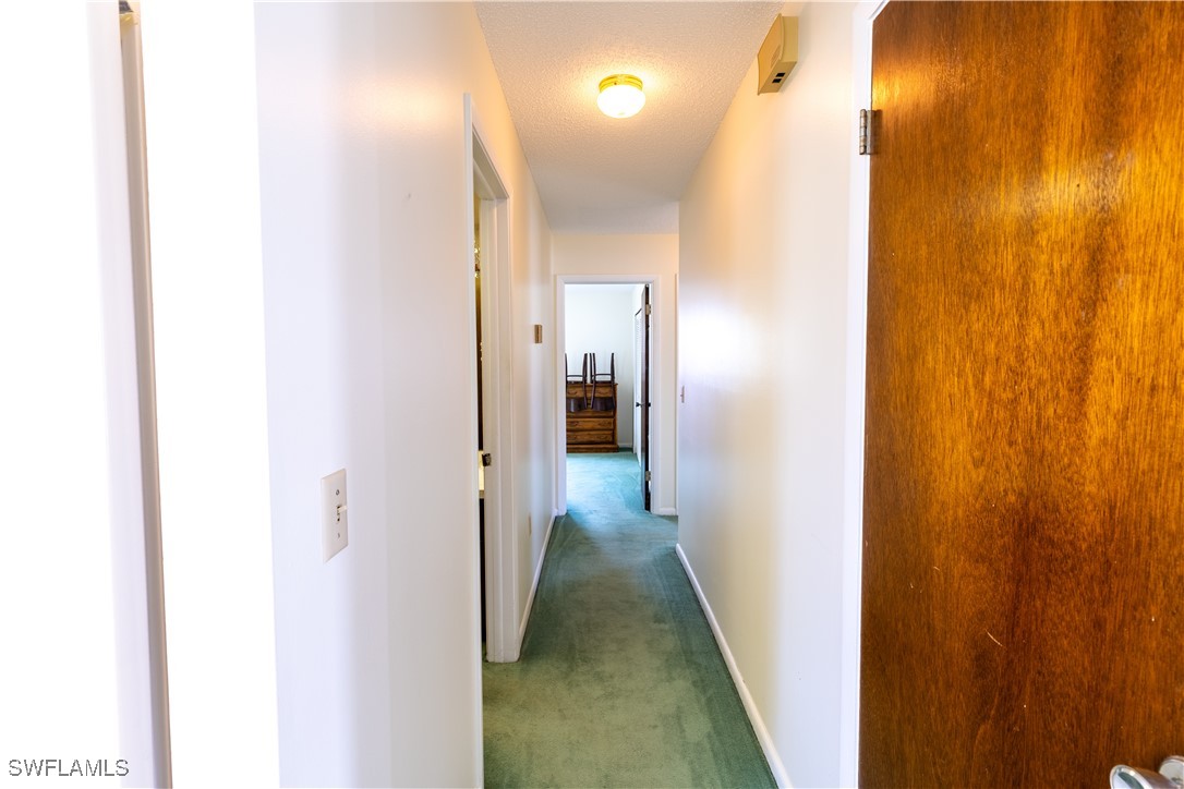 4646 Palm Tree Boulevard Cape Coral, FL 33904 - Photo 12 of 36 a view of a hallway with wooden floor