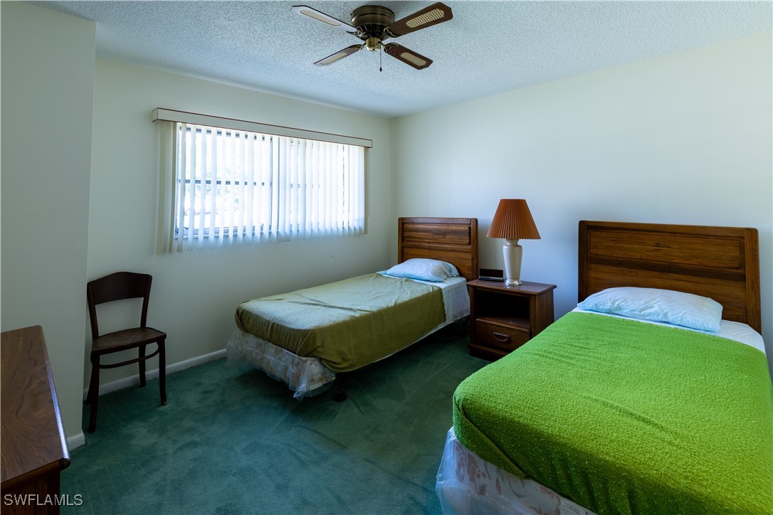 4646 Palm Tree Boulevard Cape Coral, FL 33904 - Photo 15 of 36 a bedroom with two beds and a chair