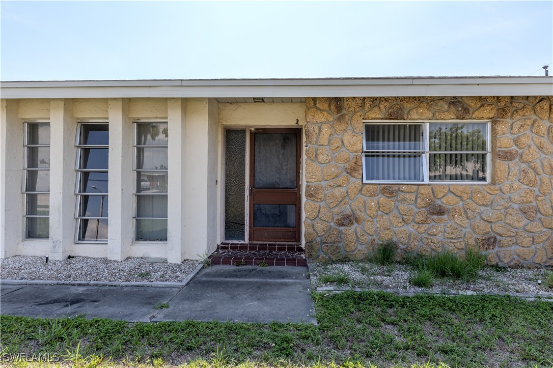 4646 Palm Tree Boulevard Cape Coral, FL 33904 - Photo 2 of 36 a front view of a house with a yard