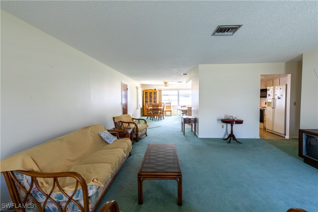 4646 Palm Tree Boulevard Cape Coral, FL 33904 - Photo 9 of 36 a bed room with a bed and a chair