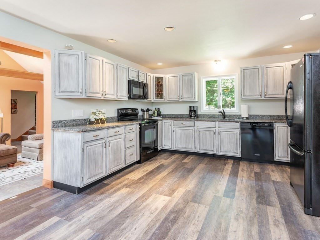 28 Cottage Road Dudley, MA 01571 - Photo 13 of 39 a large kitchen with stainless steel appliances granite countertop a stove a sink dishwasher and a refrigerator