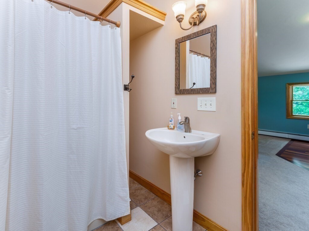 28 Cottage Road Dudley, MA 01571 - Photo 25 of 39 a bathroom with a sink a mirror and a toilet