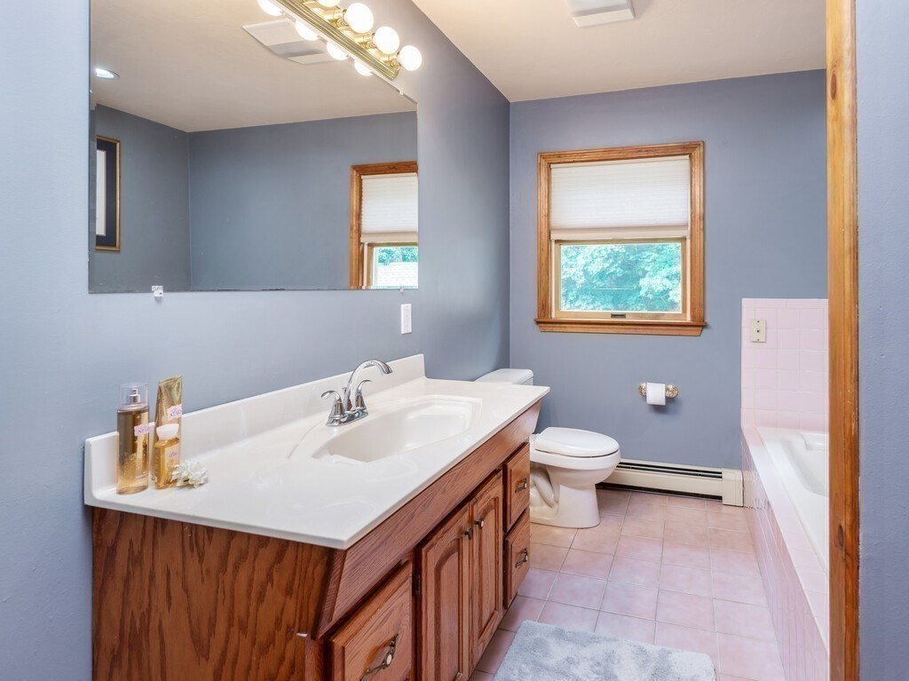 28 Cottage Road Dudley, MA 01571 - Photo 32 of 39 a bathroom with a toilet sink and mirror