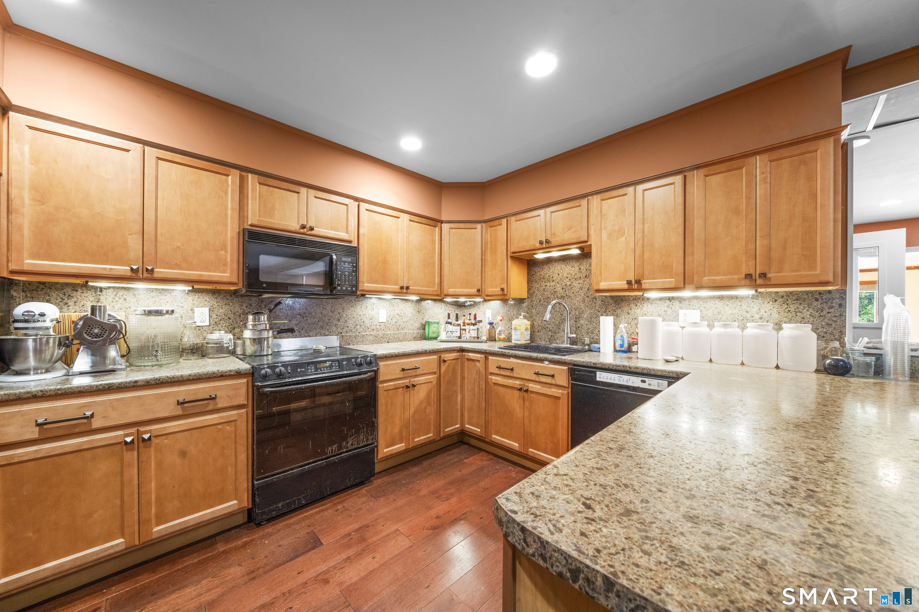 80 Holmes Road Goshen, CT 06756 - Photo 35 of 40 a kitchen with stainless steel appliances granite countertop wooden cabinets a stove top oven a sink and dishwasher with wooden floor