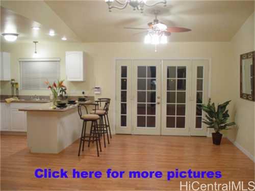 94-309 Waikele Road, Unit 1 Waipahu, HI 96797 - Photo 1 of 1 a view of a kitchen with kitchen island granite countertop a large counter space a sink and appliances