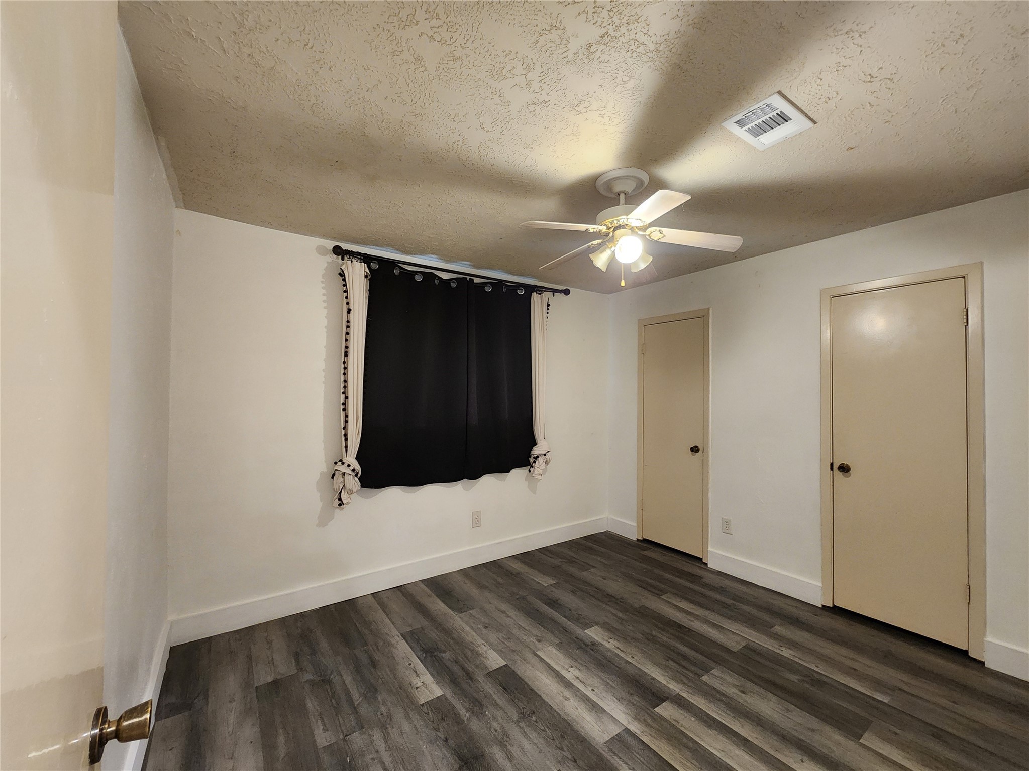 8327 Bird Run Drive Houston, TX 77489 - Photo 11 of 18 a view of an empty room with wooden floor and a window