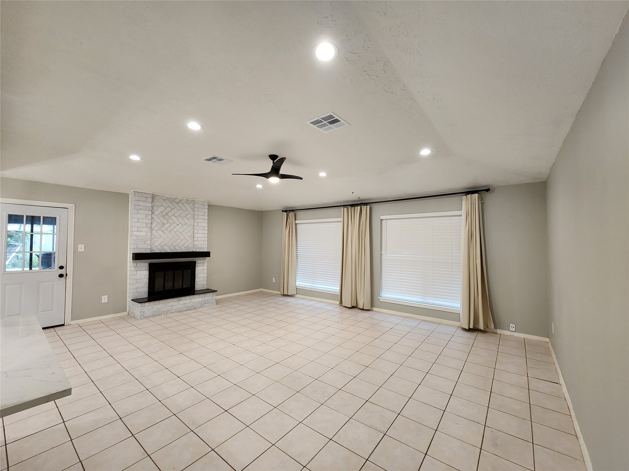 8327 Bird Run Drive Houston, TX 77489 - Photo 2 of 18 an empty room with windows and fireplace