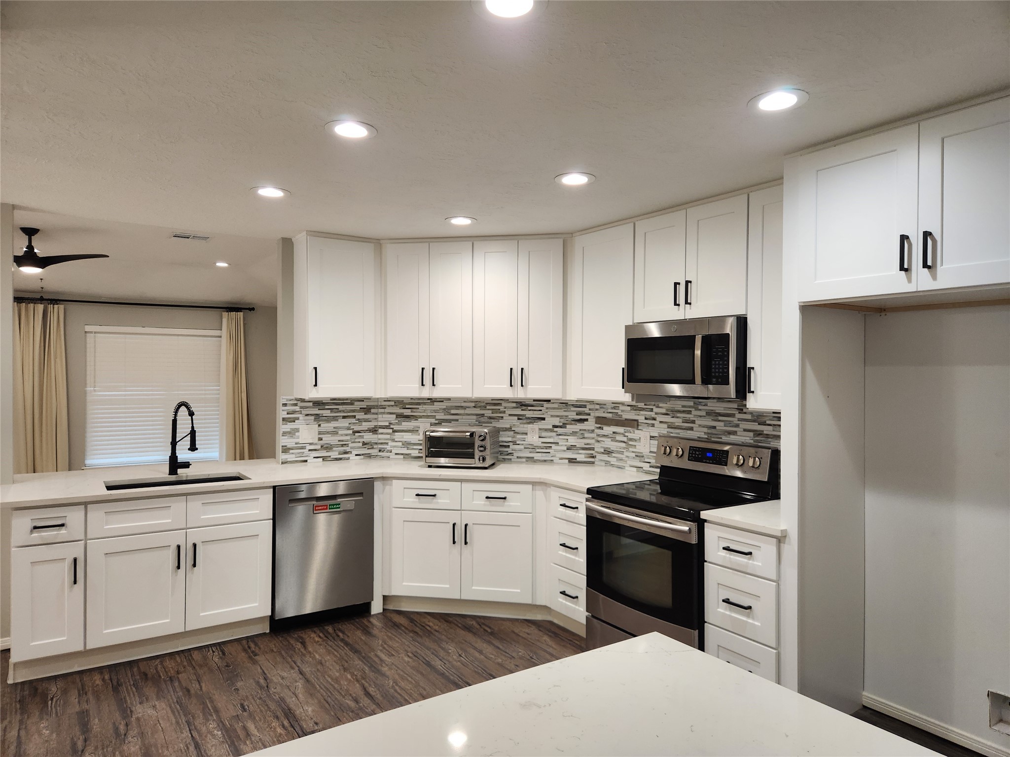 8327 Bird Run Drive Houston, TX 77489 - Photo 6 of 18 a kitchen with a sink stove and cabinets