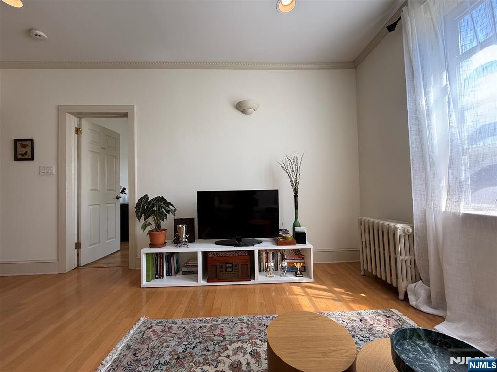 215 Orient Way, Unit C2 Rutherford, NJ 07070 - Photo 6 of 25 a room with furniture and a flat screen tv