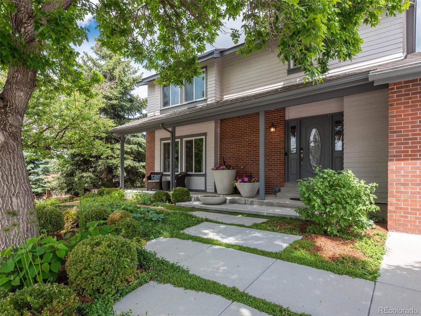 1005 Northridge Road Highlands Ranch, CO 80126 - Photo 1 of 28 a view of a house with backyard sitting area and garden