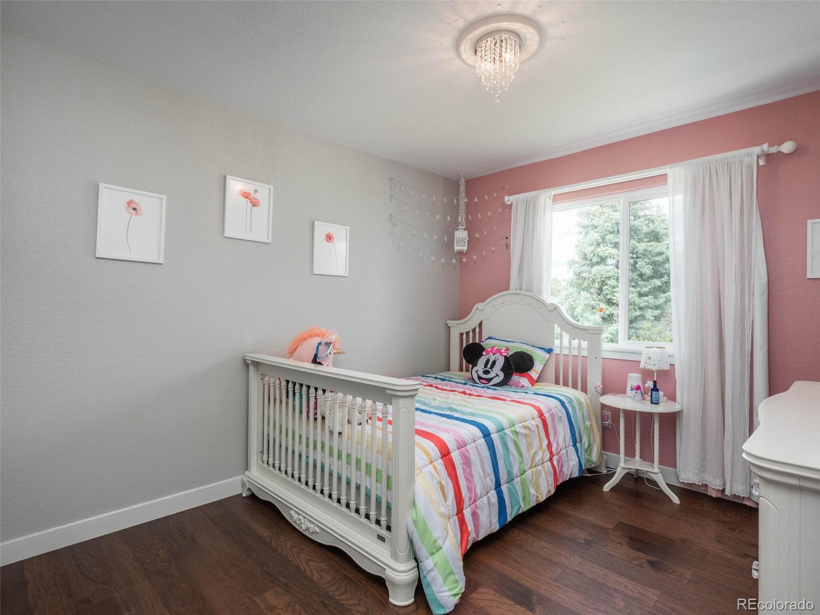 1005 Northridge Road Highlands Ranch, CO 80126 - Photo 12 of 28 a bedroom with a bed and a window