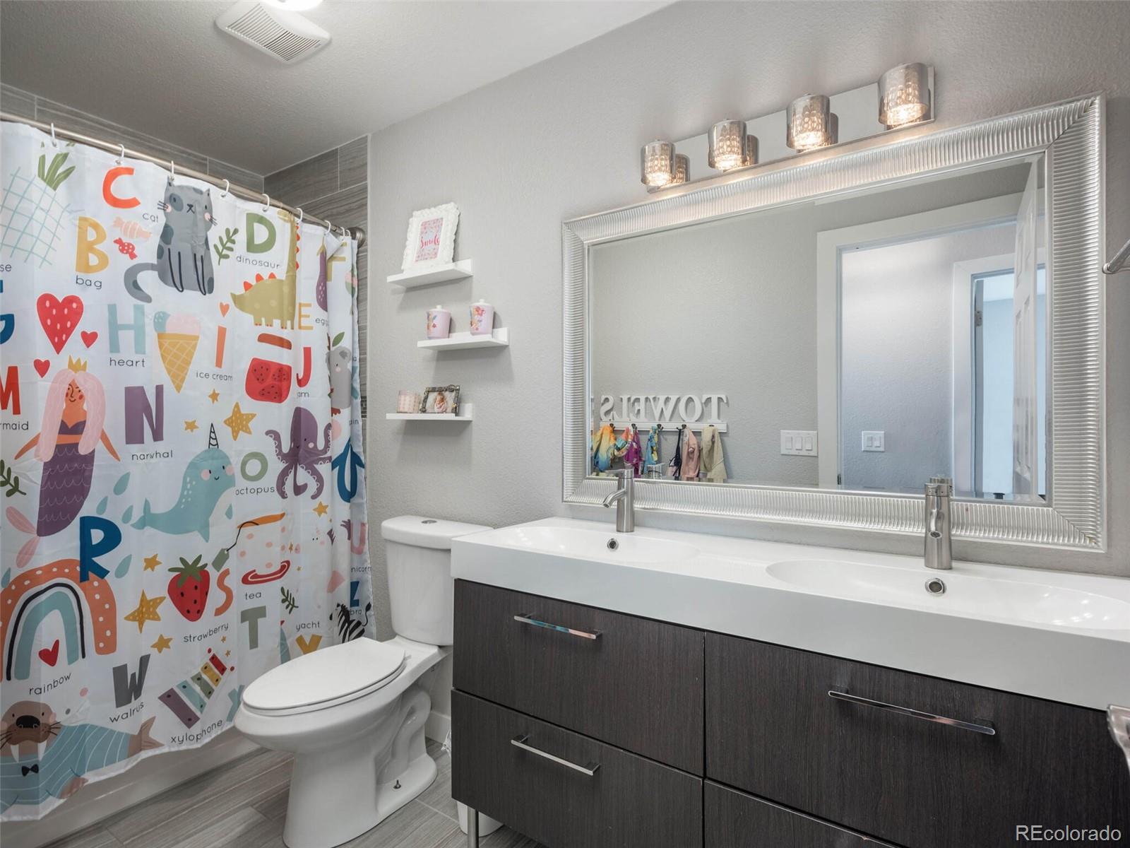 1005 Northridge Road Highlands Ranch, CO 80126 - Photo 16 of 28 a bathroom with a sink and a mirror