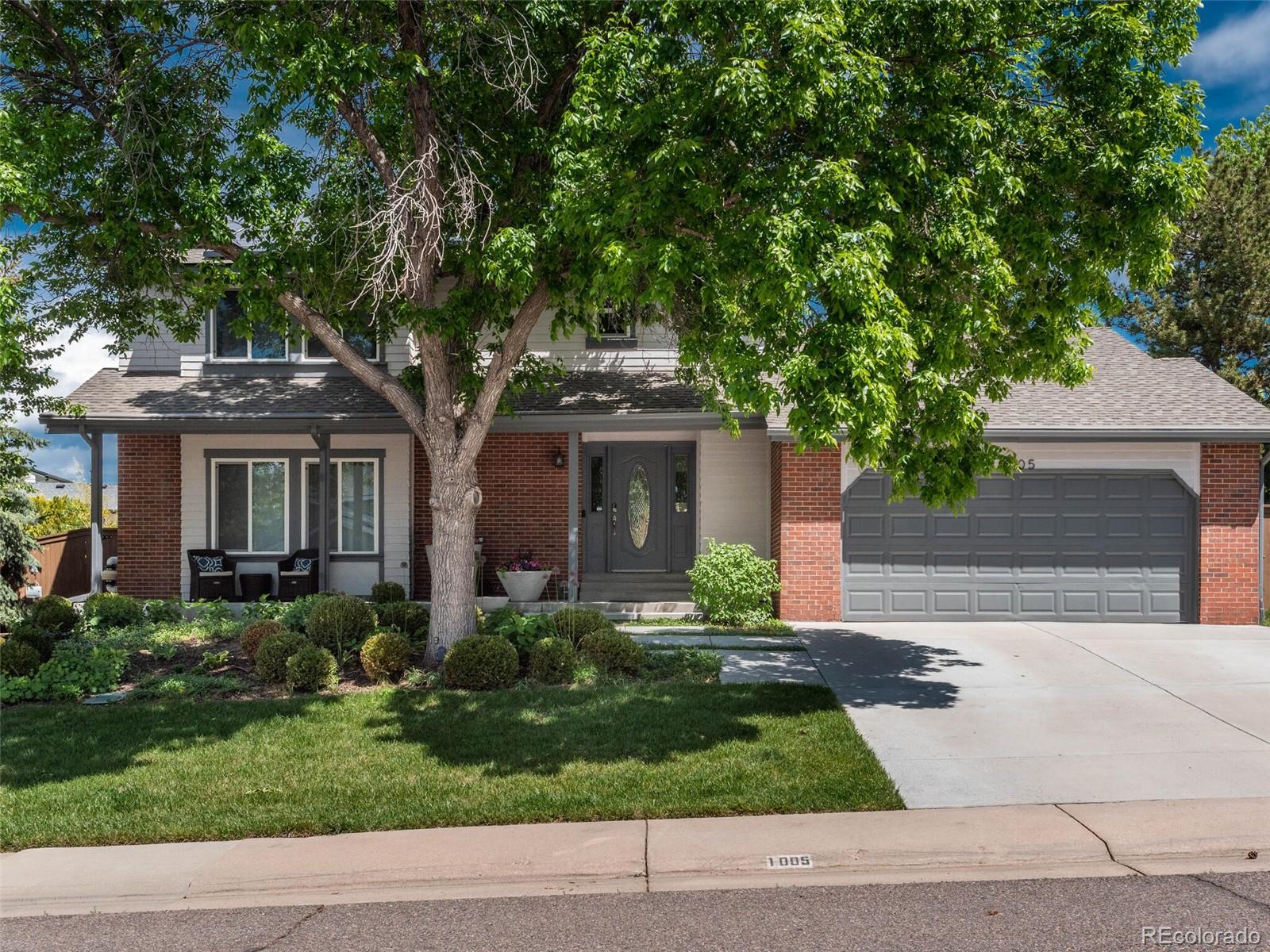 1005 Northridge Road Highlands Ranch, CO 80126 - Photo 2 of 28 a front view of a house with garden