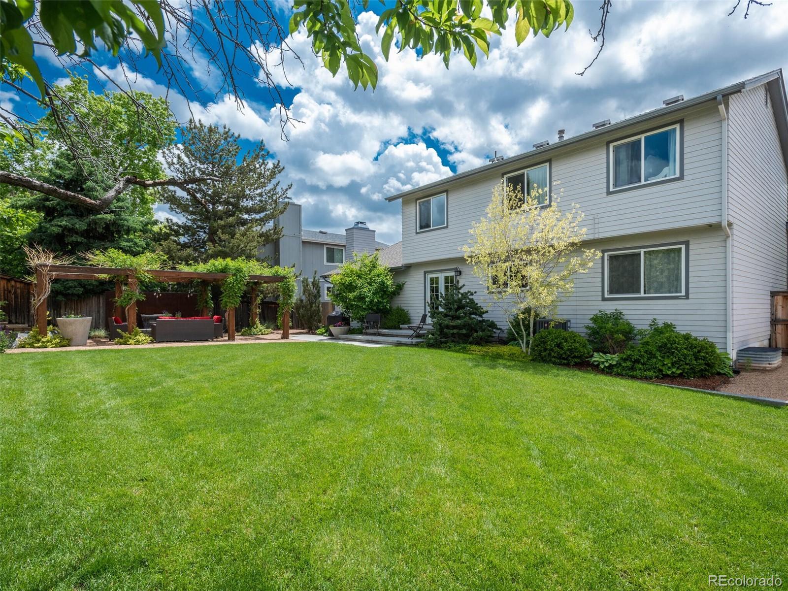 1005 Northridge Road Highlands Ranch, CO 80126 - Photo 26 of 28 a front view of a house with garden