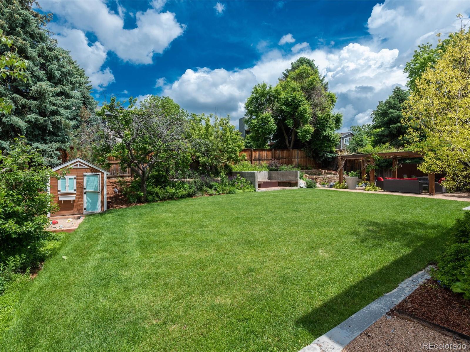 1005 Northridge Road Highlands Ranch, CO 80126 - Photo 27 of 28 a front view of a house with garden and trees