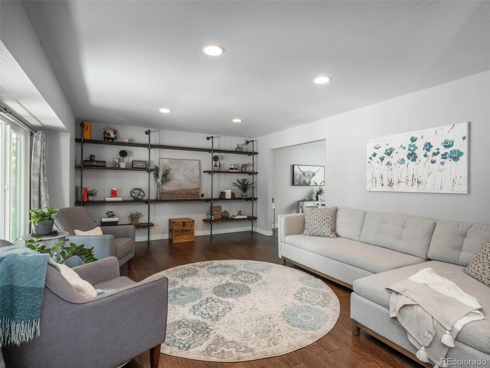 1005 Northridge Road Highlands Ranch, CO 80126 - Photo 3 of 28 a living room with furniture and a rug