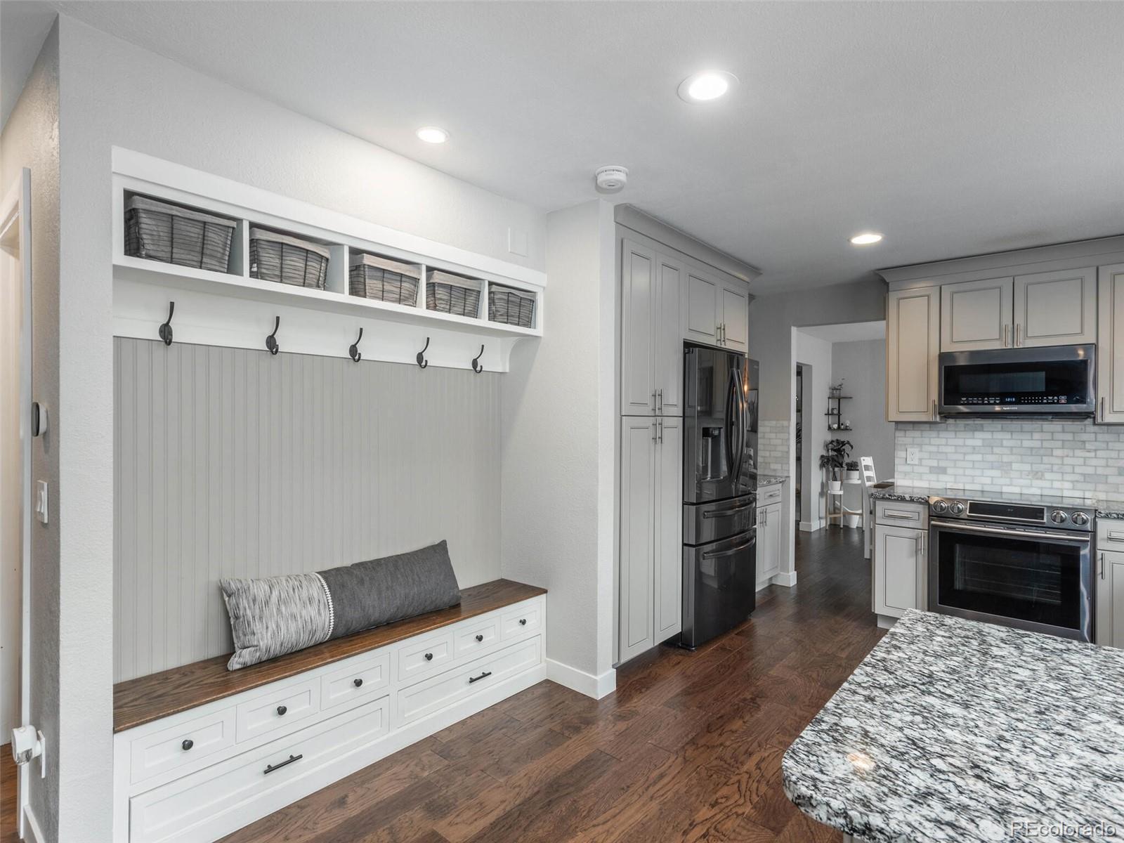 1005 Northridge Road Highlands Ranch, CO 80126 - Photo 7 of 28 a kitchen with a refrigerator and a stove top oven