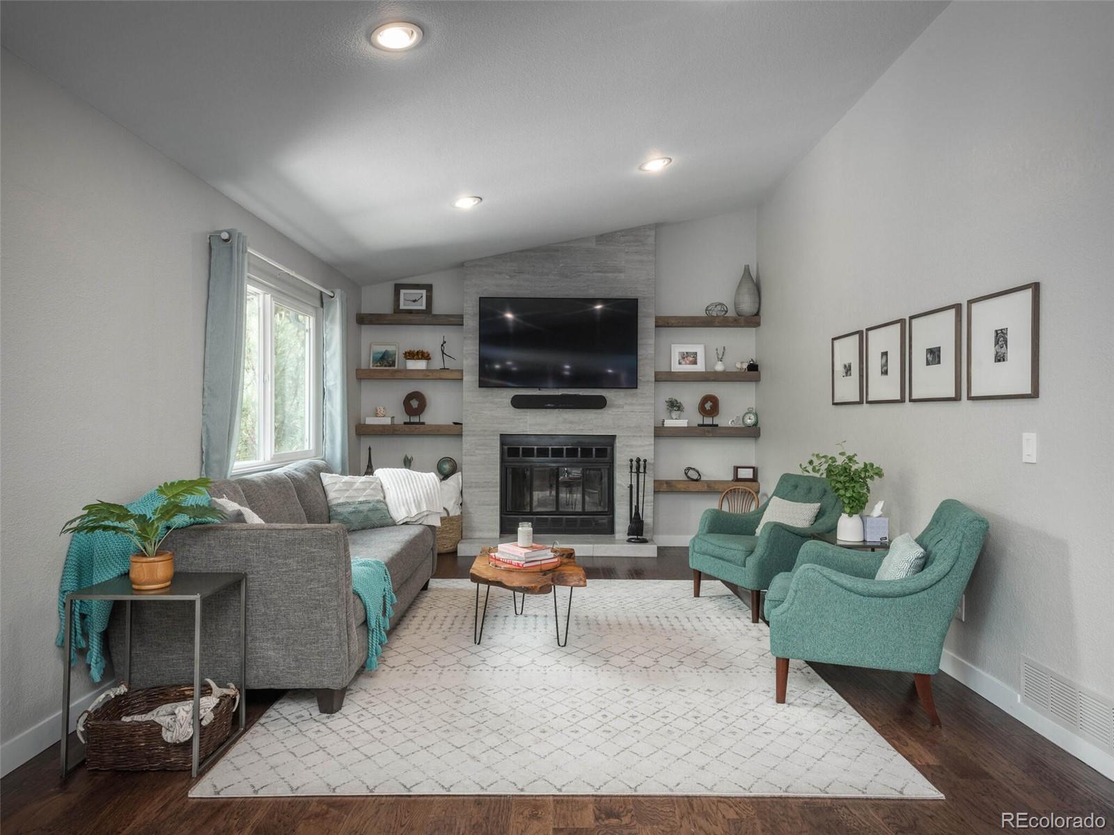1005 Northridge Road Highlands Ranch, CO 80126 - Photo 8 of 28 a living room with furniture a flat screen tv and a fireplace