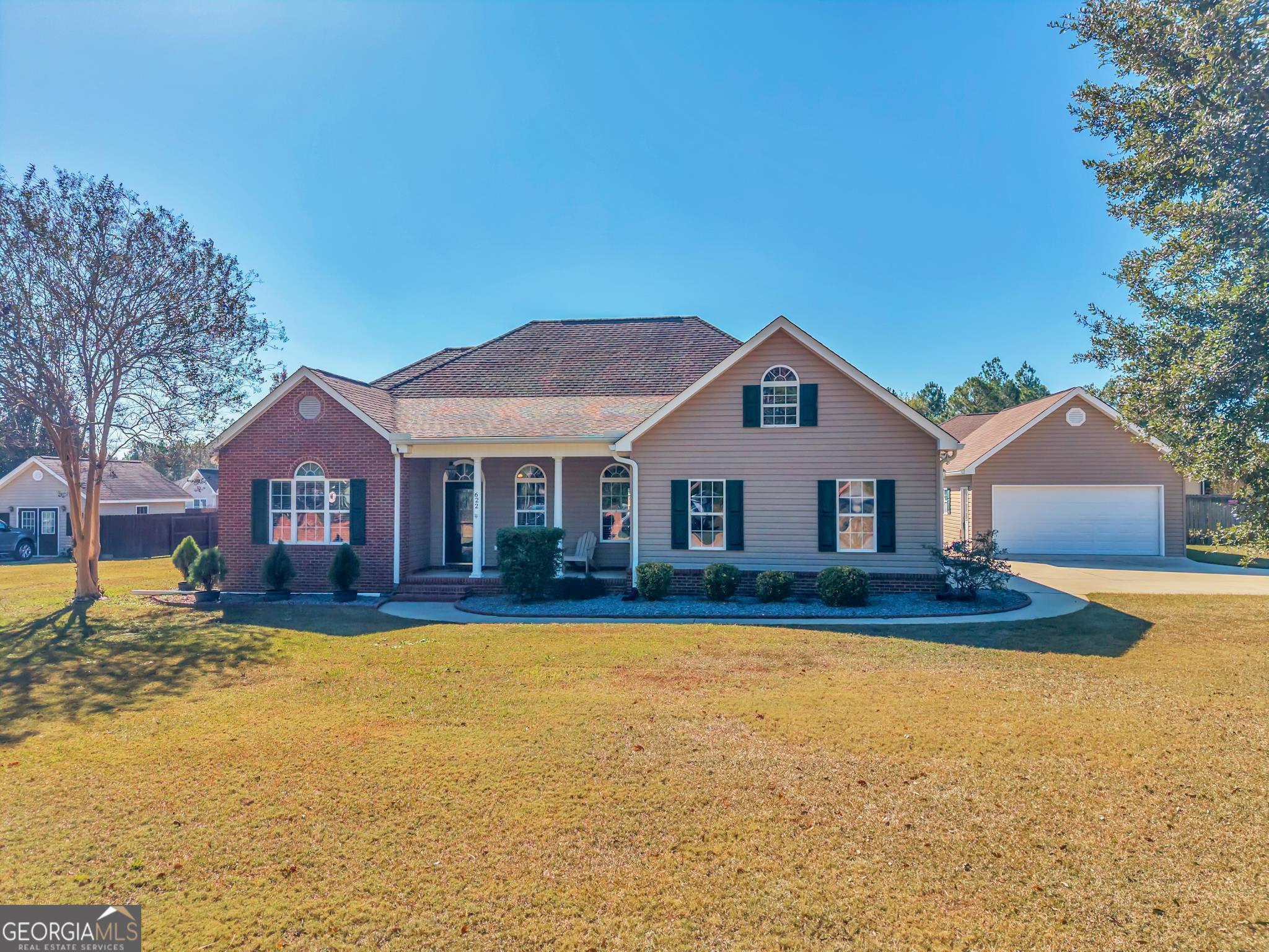 a front view of a house with a yard and garage
