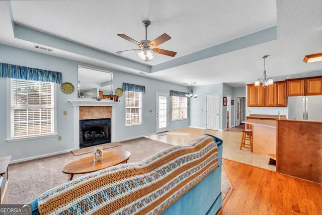 a spacious bedroom with a bed and a chandelier