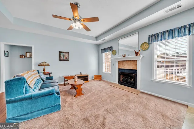 a living room with furniture and a fireplace