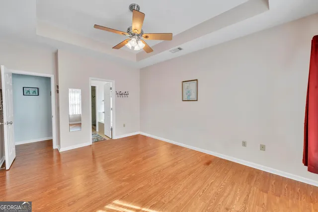 a view of an empty room with wooden floor