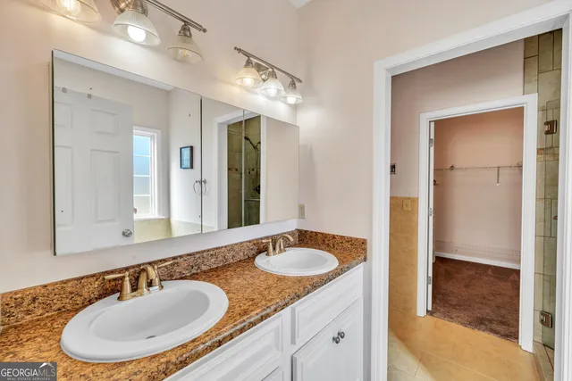 a bathroom with a sink double vanity and a mirror