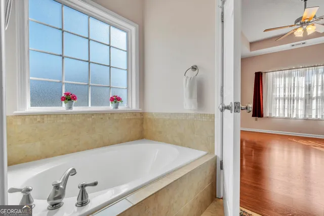 a bathroom with a tub and a sink