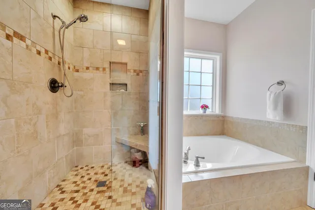 a bathroom with a bathtub and a shower