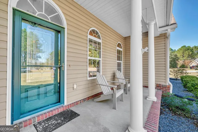 a view of a two chairs in the porch