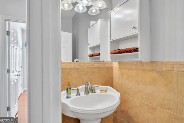 a bathroom with a sink a mirror and a toilet