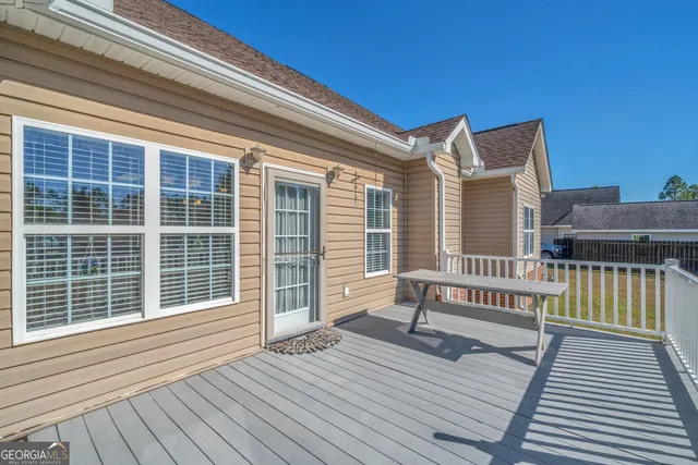 a view of a deck with wooden floor and fence