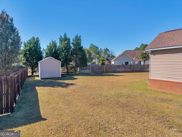 a view of a backyard and basketball court