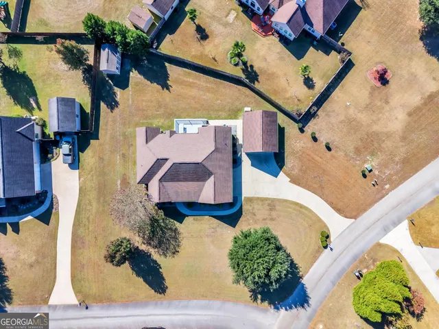 an aerial view of a house with a swimming pool