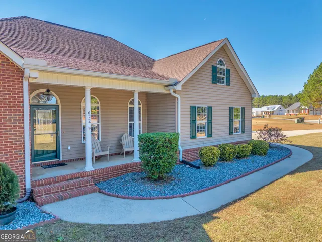a front view of a house with garden