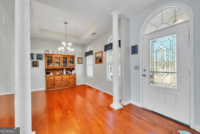 a view of empty room with wooden floor and fireplace