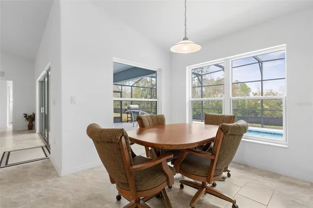 a dining room with furniture a chandelier and wooden floor