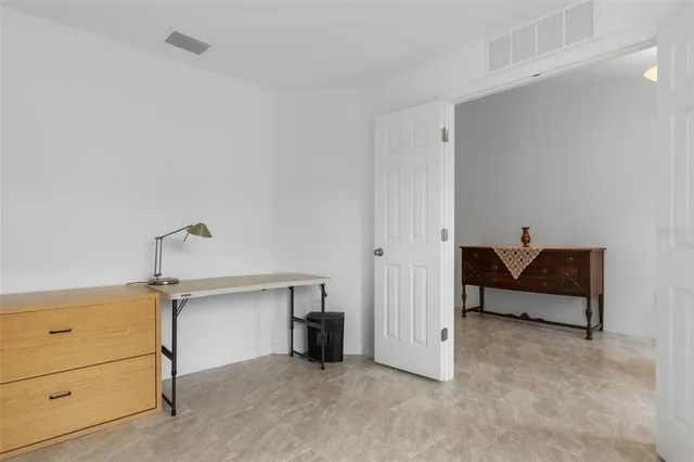 a bedroom with a large bed and a large window