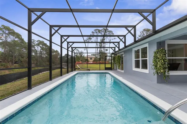 a view of swimming pool with a patio