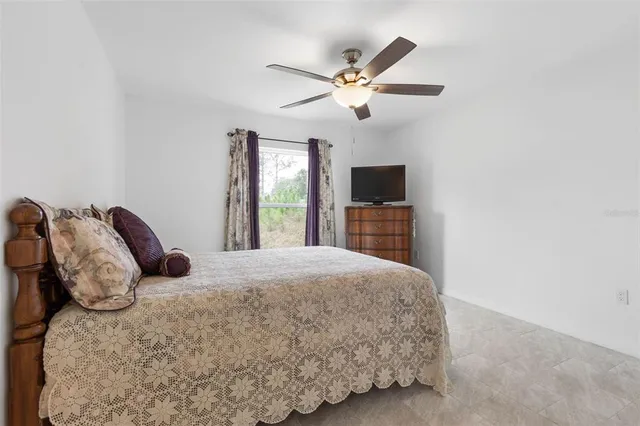 a bedroom with a bed and a chair