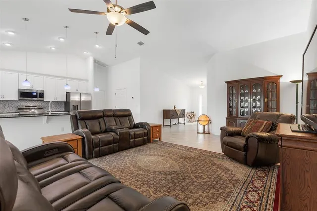 a living room with furniture and kitchen view