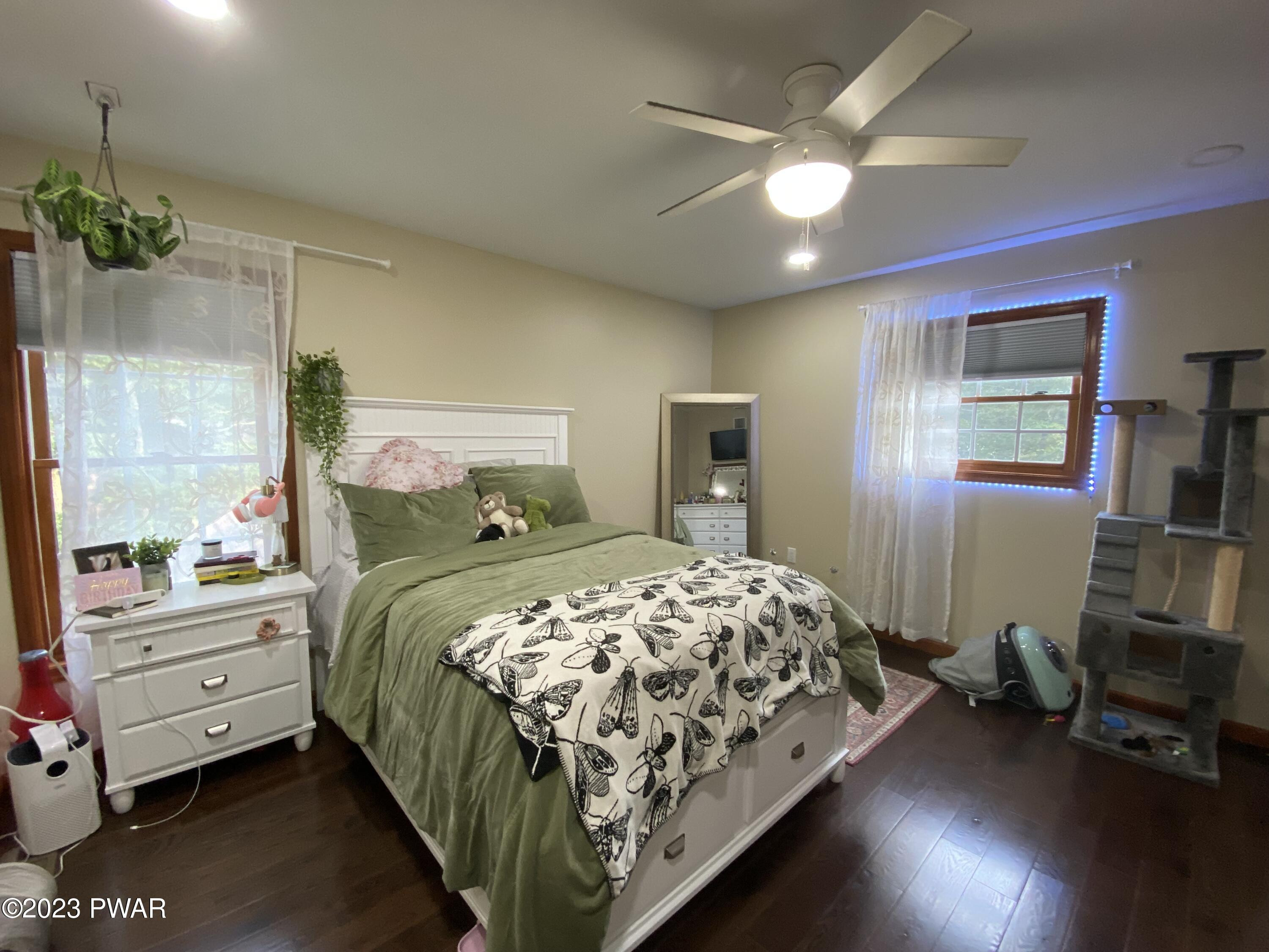 126 Maple Ridge Road Milford, PA 18337 - Photo 39 of 52 a bedroom with a bed and a chandelier