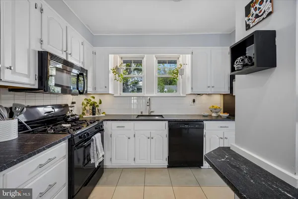 a kitchen with stainless steel appliances a stove sink microwave and cabinets
