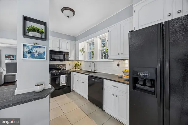 a kitchen with stainless steel appliances a refrigerator sink and microwave