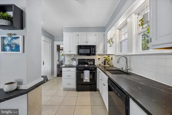 a kitchen with a sink and a stove top oven