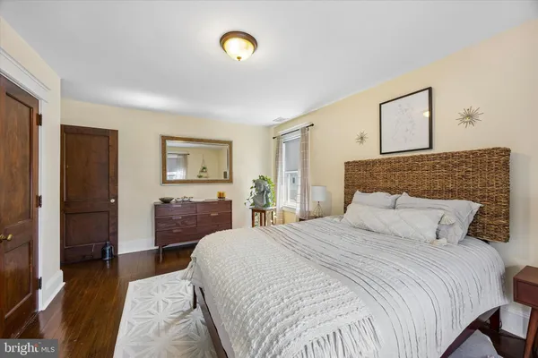 a bedroom with a bed and a large mirror