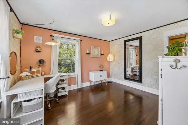 a view of a livingroom with furniture window and wooden floor